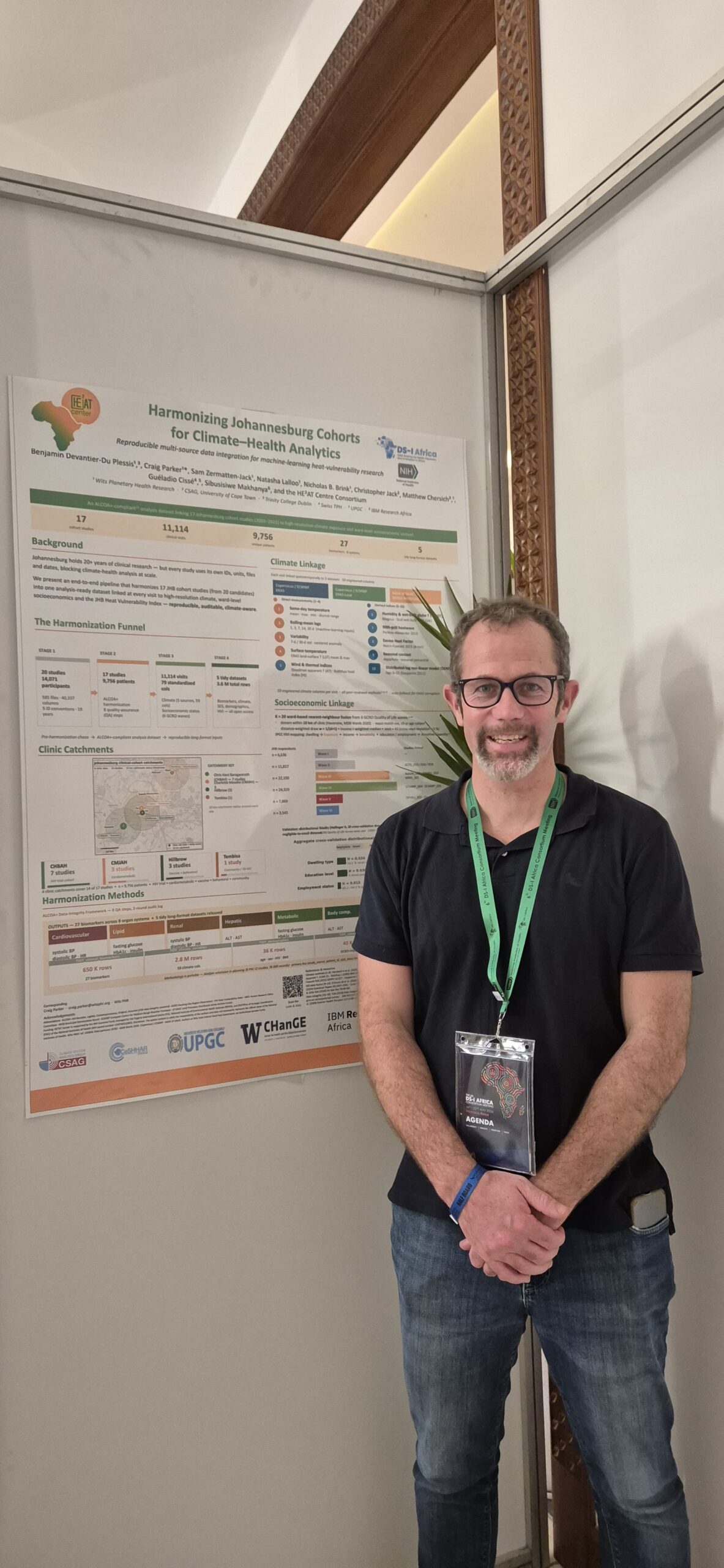 Craig Parker standing beside the Harmonizing Johannesburg Cohorts for Climate-Health Analytics poster